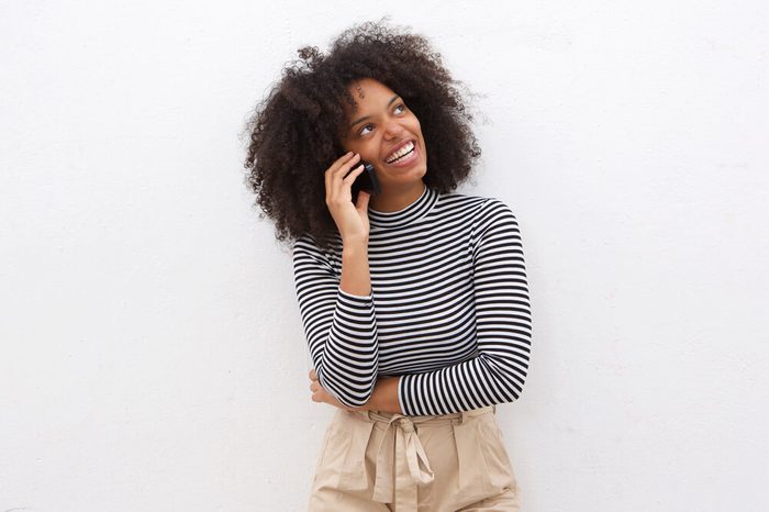 Portrait of happy black woman talking on mobile phone