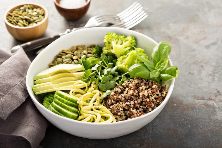 Green and healthy vegan grain bowl with quinoa, avocado, cucumber and zucchini noodles