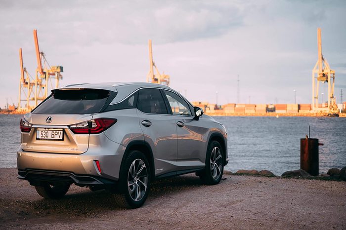 RIGA, APRIL 2016 - A Lexus RX450h hybrid luxury SUV is parked near river with a view of freight port in the background