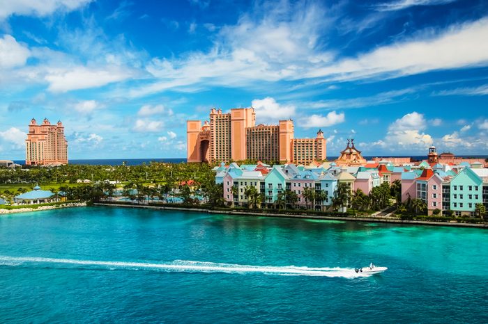 Beautiful scene of speed boat, ocean, colorful houses and a hotel in Nassau, Bahamas on a summer sunny day