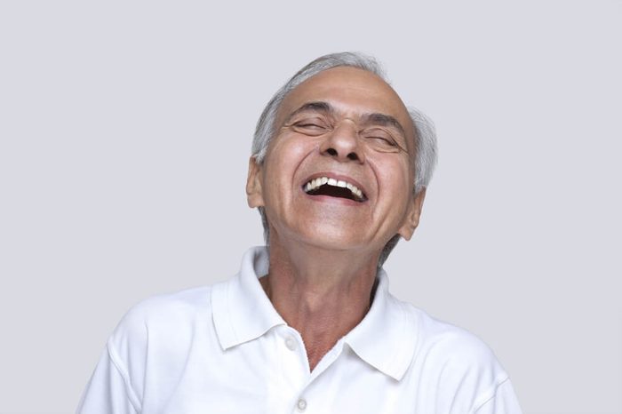 Excited man laughing with eyes closed