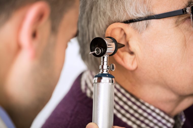 Doctor Examining old Patient's Ear
