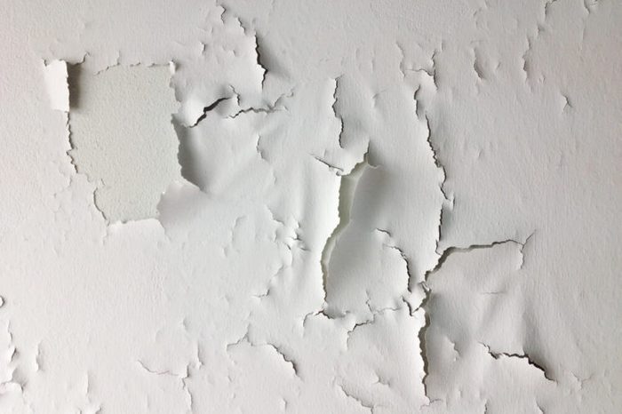 Cracked wall, Paint white peeling off an old interior wall.
