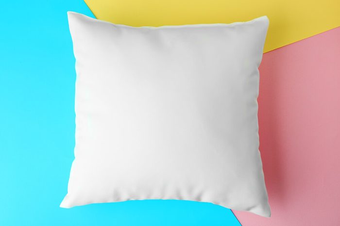 Blank pillow on color paper background