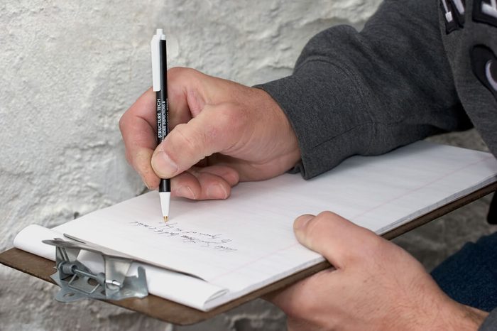 A housing inspector making notes during an inspection