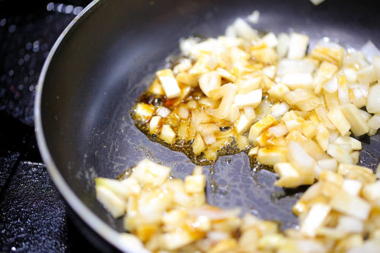 White onion finely chopped and poured into a pan, Onions into the pan