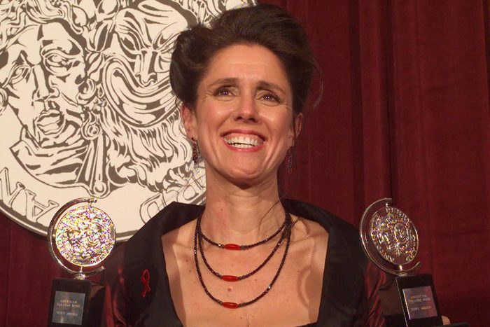 TAYMOR Julie Taymor holds her two Tony Awards backstage at New York's Radio City Music Hall . Taymor, the driving force behind "The Lion King," won for Best Direction of a Play and for Best Costume Design