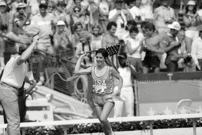 Twenty-seven-years-old Joan Benoit of Freeport, Maine, waves the American flag enthusiastically in Los Angeles after finishing the first-ever Olympic women's marathon in the fastest-ever time for that distance. 2.24:52 for the 26-mile, 385-yard course