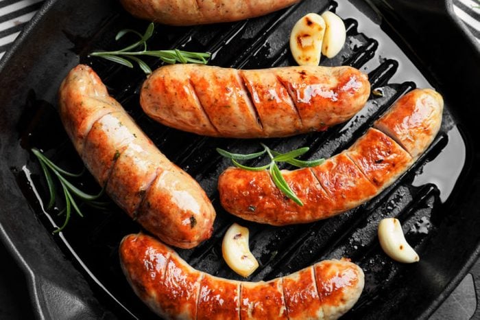 Grill pan with delicious grilled sausages, close up