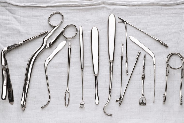 set of surgical instruments on white gauze