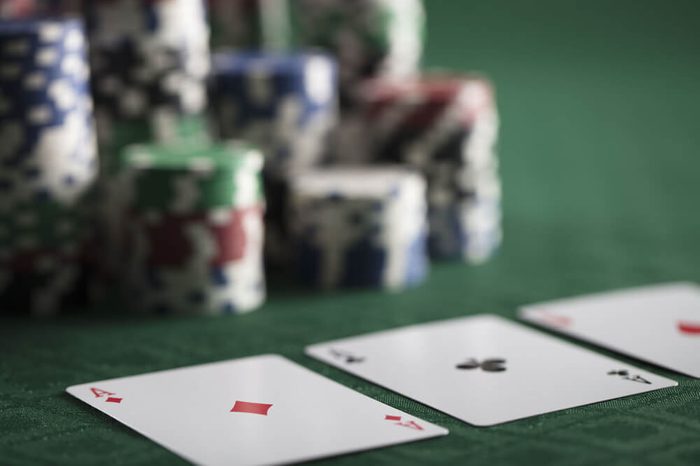 Poker gamer. Poker chips on green canvas.