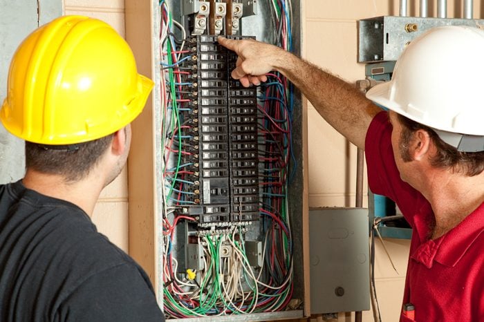Electricians identify a 20 amp breaker that has gone bad and replace it.