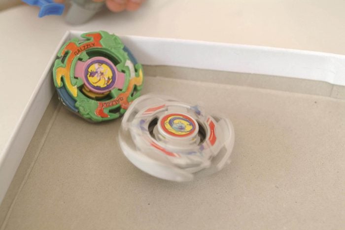 MODEL RELEASED Boys plays with beyblade