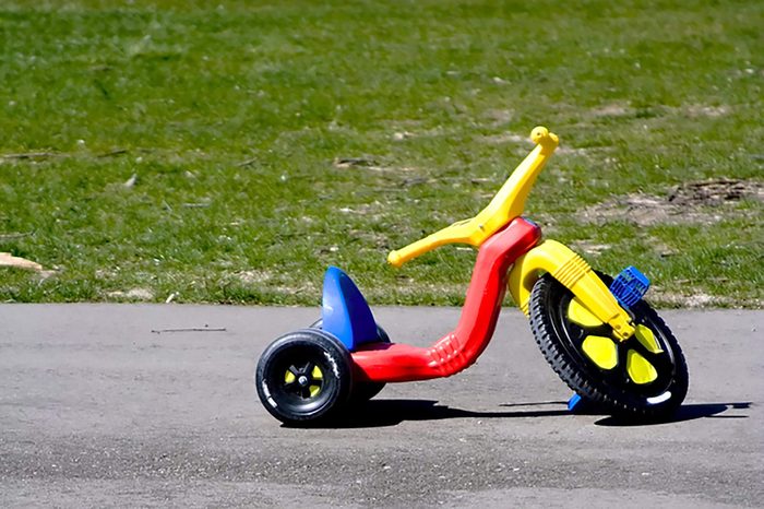 Childhood red and yellow plastic tricycle big front wheel