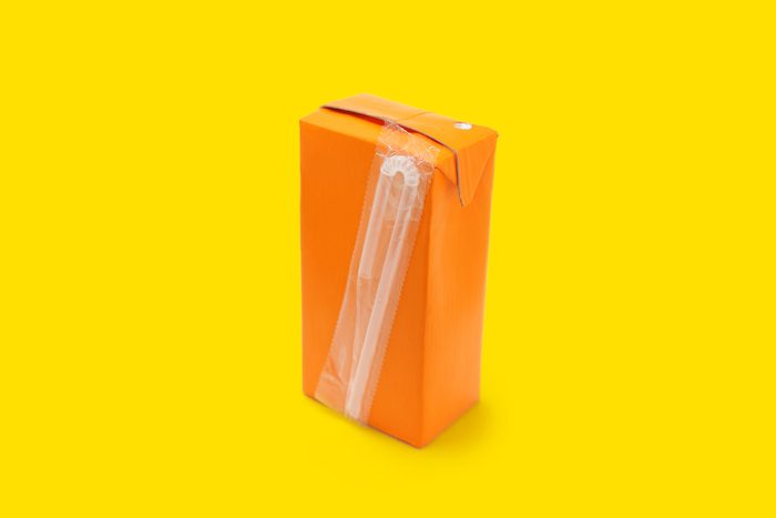 orange juice box on yellow background