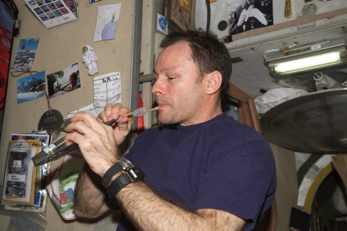Astronaut Michael E. Lopez-Alegria, Expedition 14 commander and NASA space station science officer, drinks a beverage in the Zvezda Service Module of the International Space Station.