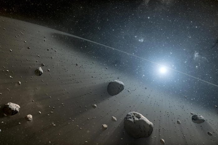 This artist concept illustrates an asteroid belt around the bright star Vega. Evidence for this warm ring of debris was found using NASA Spitzer Space Telescope, and the European Space Agency Herschel Space Observatory.