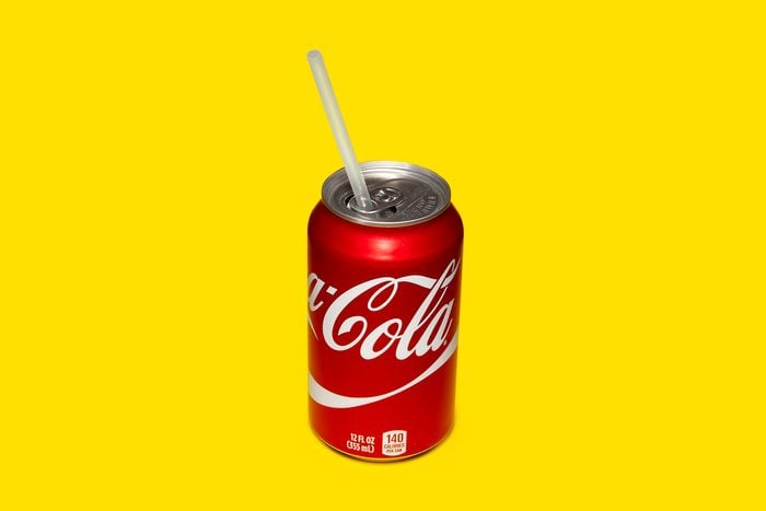 can of soda with the tab turned toward the opening to hold a drinking straw