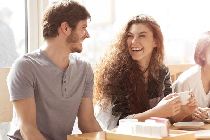 Shot of two young cheerful friends talking in a cafe laughing joyfully. Beautiful young woman laughing excitedly with her male friend people relationships couple date friendship leisure lifestyle