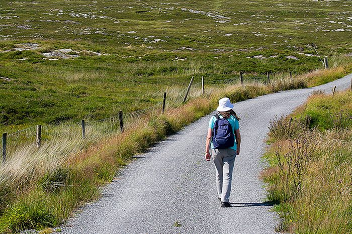 Bantry,Ireland - July 12, 2017: Hiker on Country Lanes in County Cork, Ireland