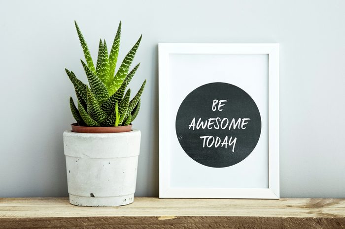 white frame BE AWESOME TODAY with succulent in diy concrete pot. Scandinavian hipster style room interior