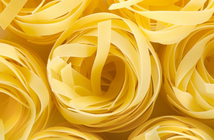 Photo of the yellow raw pasta background
