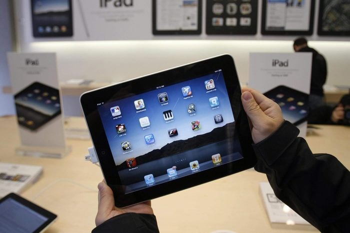 Showing customer uses an Apple iPad on the first day of Apple iPad sales at an Apple store in San Francisco. Apple said, it has sold 1 million of its new iPad tablet computers in the month after its launch, meaning it's been selling more than twice as fast as the iPhone did when it was new