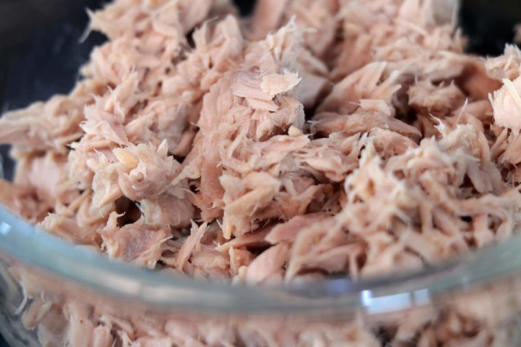 close up Bowl of canned tuna on black kitchen table