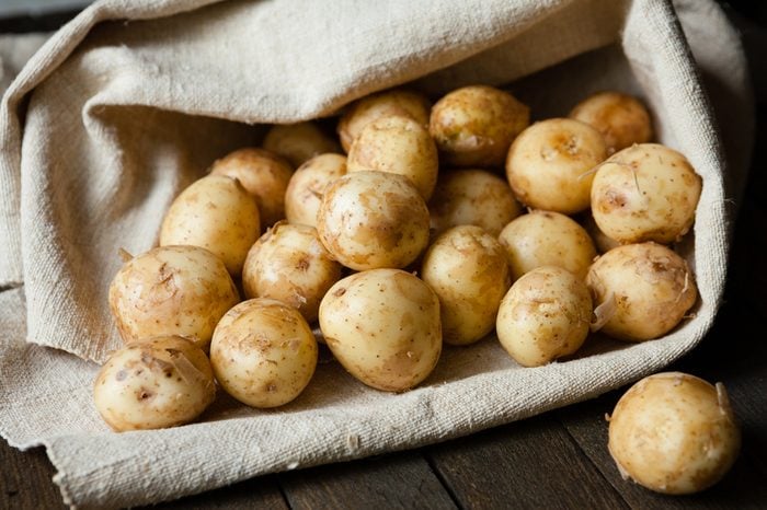 new potatoes with the peel on the table in a bag, food close up