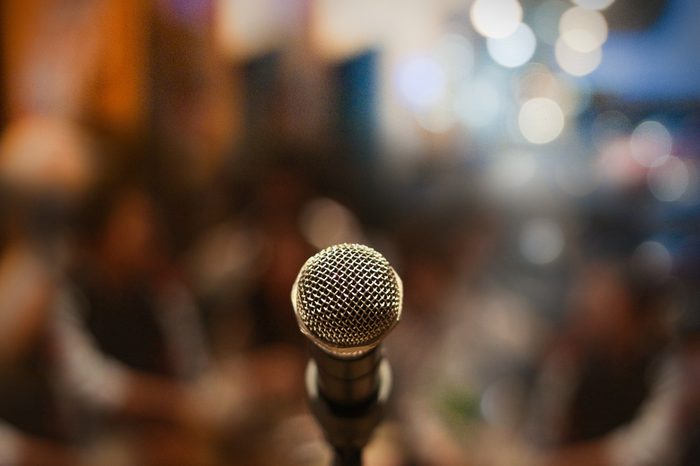 Close up of microphone on stage in audience room blur background.