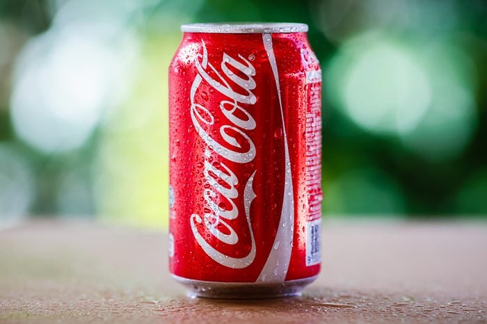 SABAH, MALAYSIA April 10, 2015 : Coca-Cola can with background blurring tree in a park. suitable for decorating supermarkets and restaurants