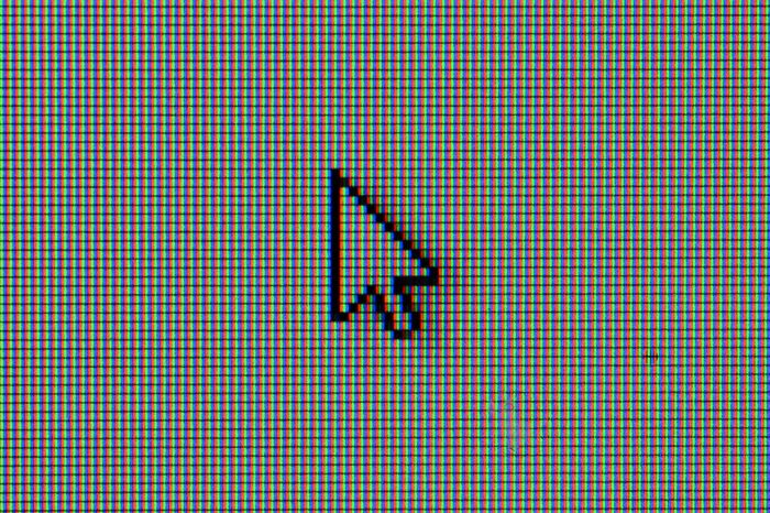 Macro detail of computer cursor on the screen formed by RGB pixels