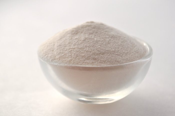 Xanthan gum - a white powder of plant origin for gluten free baking and cooking, closeup on white background
