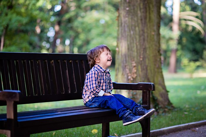 Upset little baby boy crying outdoors. Toddler having tantrum in the park