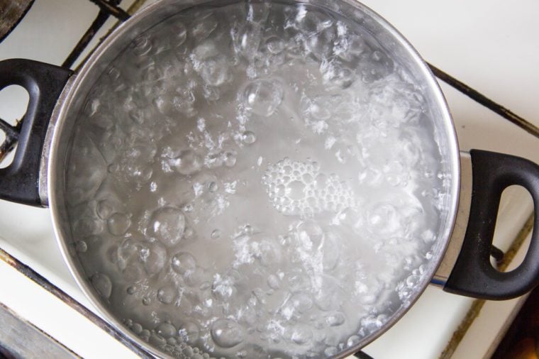 Pot full of boiling water on the stove