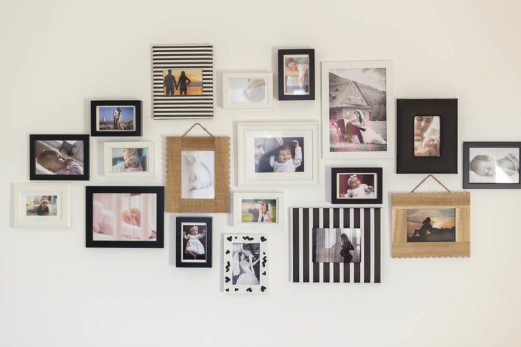 white wall with photos of the family in various photo frames