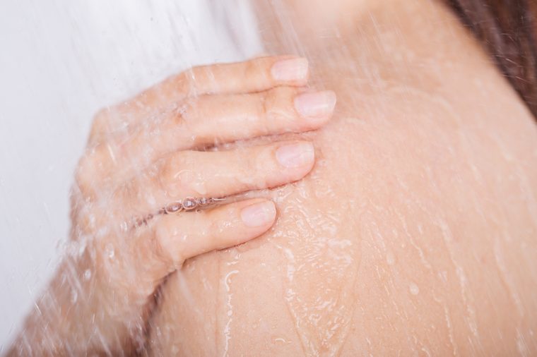 close up hand with shoulder of woman which take a shower
