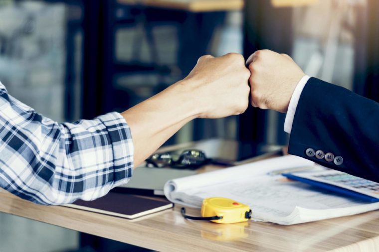 Success Business Partners Giving Fist Bump after Complete a Deal. Successful Teamwork with Hands Gesture Communication. Businessman with Team Agreement in Corporate. Partnership Business Concept