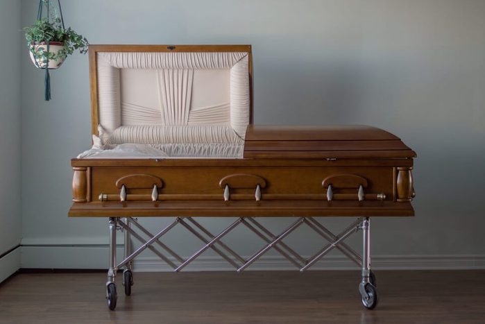 head on open wooden coffin in funeral home