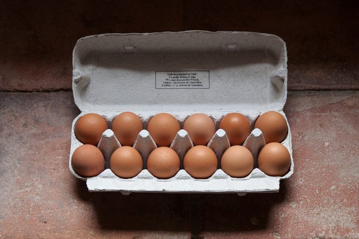 A dozen eggs in an egg cup