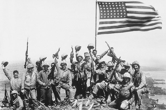 Associated Press International News Japan WWII U.S. MARINES FLAG IWO JIMA U.S. Marines of the 28th Regiment, fifth division, cheer and hold up their rifles after raising the American flag atop Mount Suribachi on Iwo Jima, a volcanic Japanese island, on during World War II