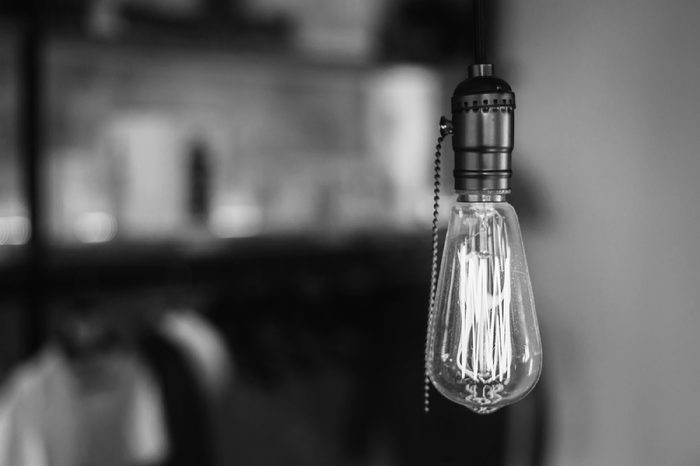 Vintage light bulb on coffee shop background