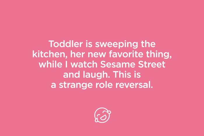 toddler is sweeping the kitchen
