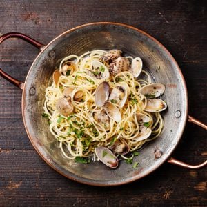 Seafood pasta with clams Spaghetti alle Vongole on wooden background