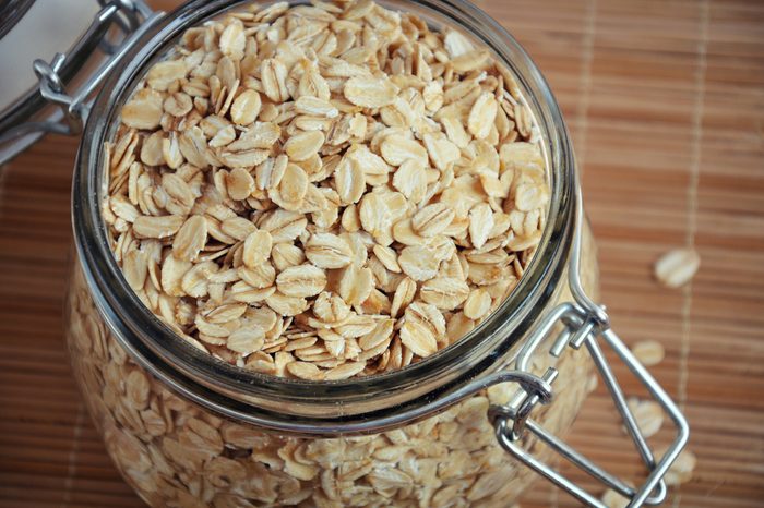 Rolled oats or oat flakes in jar. Healthy lifestyle concept. Top view, closeup.