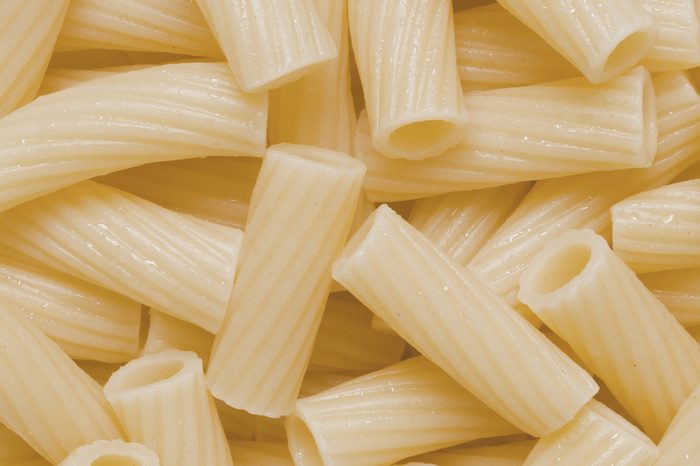 close up of cooked maccheroni pasta tubes food texture background