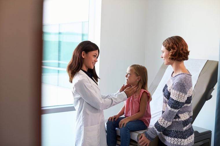 Pediatrician Meeting With Mother And Child In Exam Room