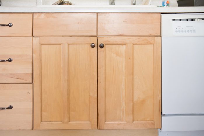 Front view of light wood kitchen cabinet