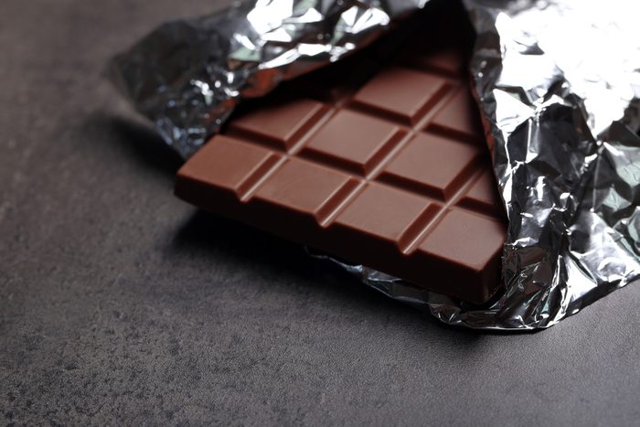 Chocolate bar in foil on gray background