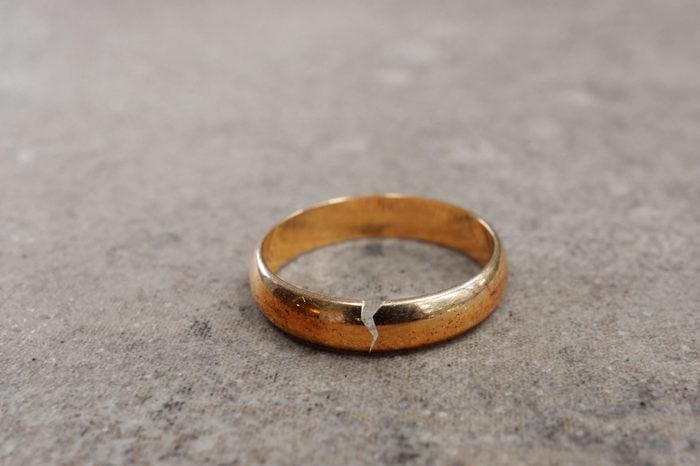 Gold wedding ring with a crack in it -- divorce concept 